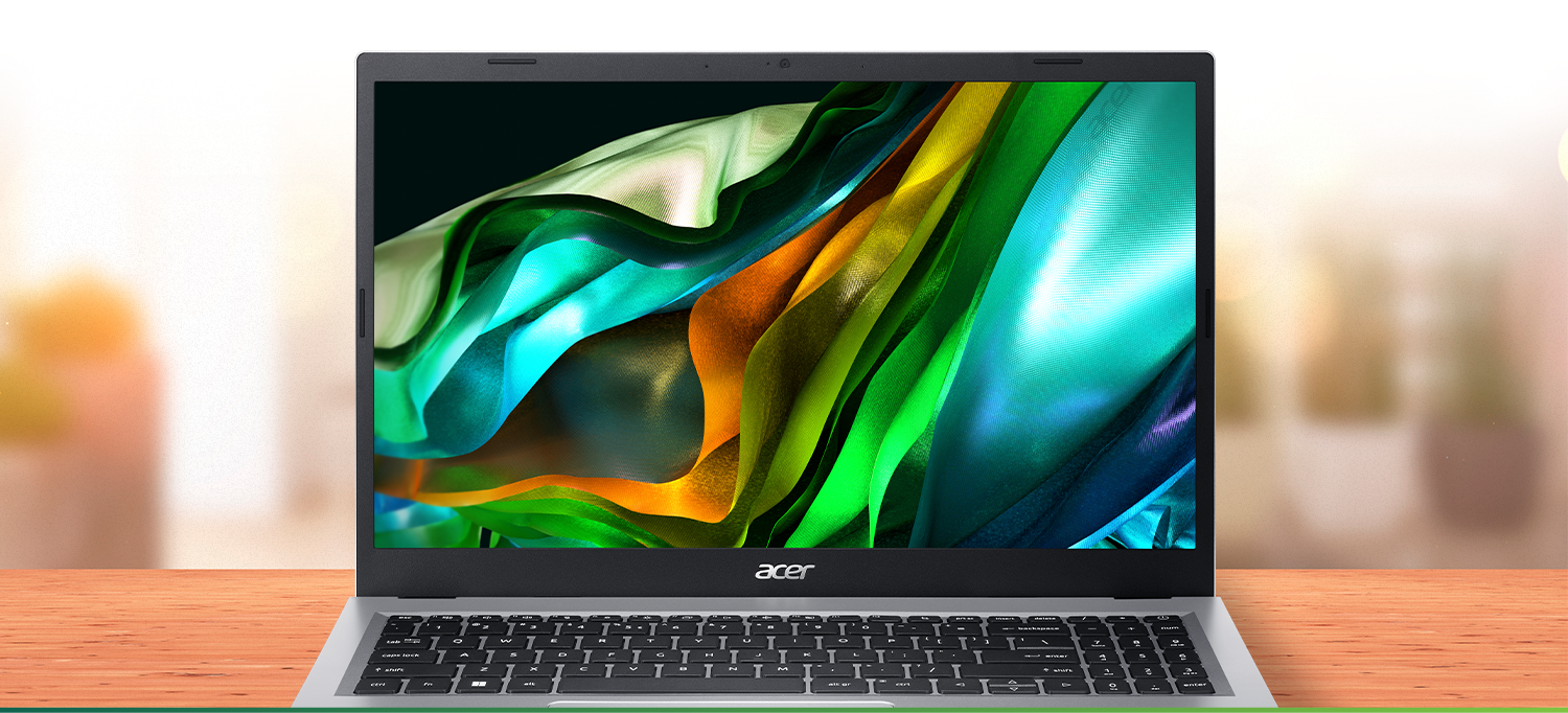 Notebook Acer Aspire 3 visto de frente com imagem abstrata em azul, verde e laranja na tela, sobre uma mesa.