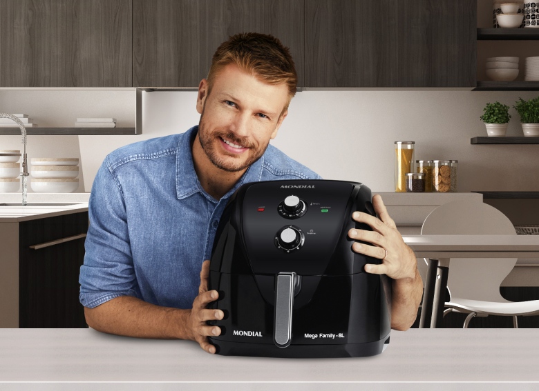 homem segurando air fryer